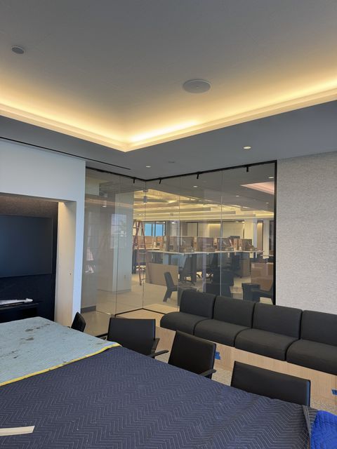 Santa Monica office conference room with its glass corner partition clear, the office fit-out visible beyond