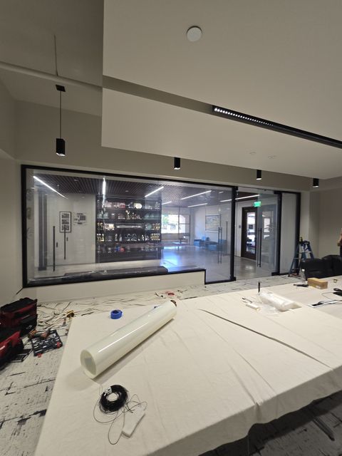 Switchable smart film retrofit preparation showing proper glass-prep and clean-room standard before application