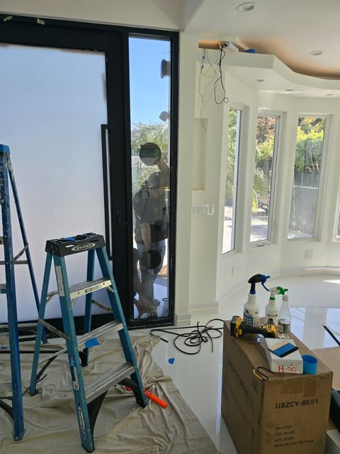 Switchable film being installed on a residential glass door
