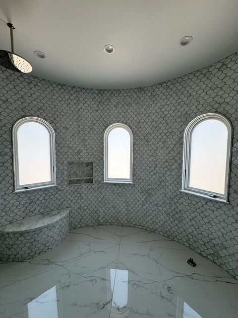 Custom-cut smart glass shower Torrance — 65 sqft PDLC smart film on six arched-top bathroom windows by Smart View