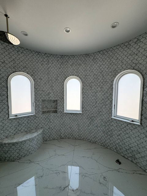 Custom-cut smart glass shower Torrance — 65 sqft PDLC smart film on six arched-top bathroom windows by Smart View