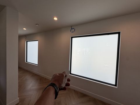 Smart glass windows Tarzana — picture window and clerestory in frosted state with wireless remote toggling both together