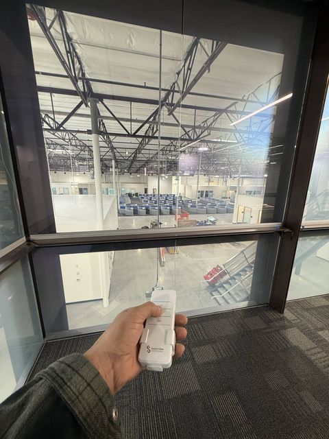 Real Smart View install: glass-walled office at Upper Deck in Carlsbad with switchable smart film powered clear, workspace visible through the glass