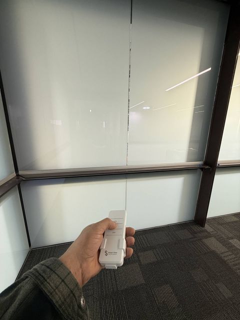 The same Carlsbad glass wall switched off, showing the flat, even white frost of PDLC smart film's opaque state