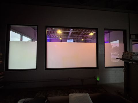 Real Smart View install at a Ventura gym: smart glass partition in the clear state, training room and equipment visible through the panels
