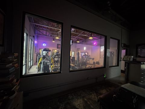 Gym training room visible through smart glass window in Ventura CA