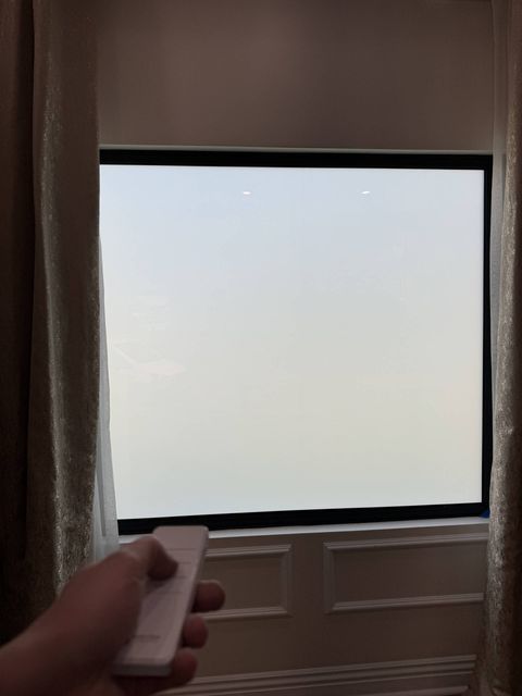 The same La Cañada Flintridge window seconds later with the smart film switched to a flat, even white frost for privacy