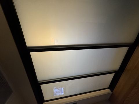 The same Pasadena bedroom partition switched to a flat milky-white frost, screening the room on one switch