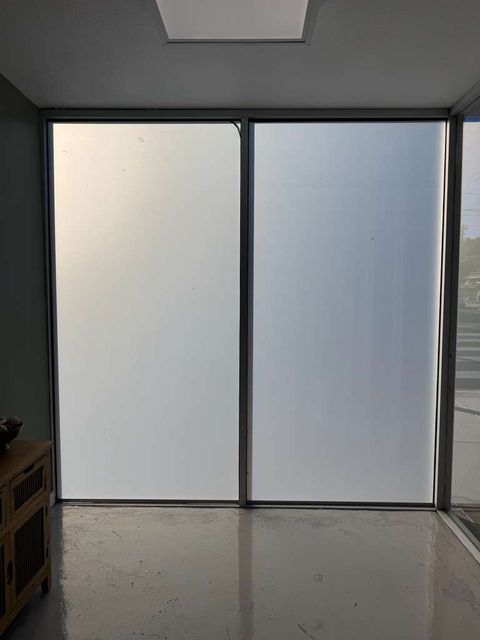 Two large retrofitted glass panels in frosted mode, privacy and diffused sunlight in a residential space