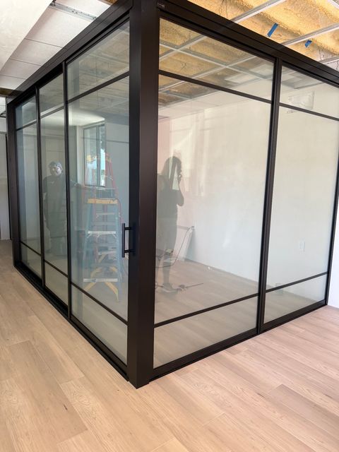 Switchable PDLC smart glass enclosure on a conference room in an LA open-plan office layout