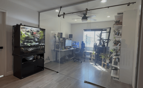 Smart glass study room Buena Park — clear state of sliding glass door and walls showing home office with aquarium and desk