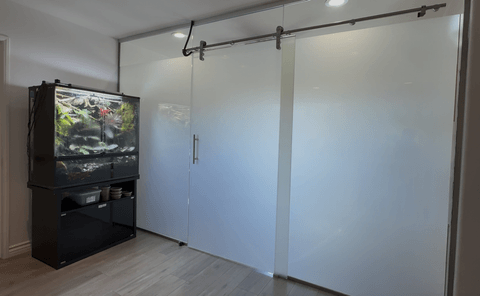 Smart glass study room Buena Park — frosted state of sliding glass door and walls fully private with aquarium visible