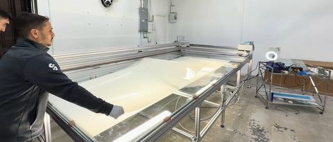 A Smart View team member assembling a large PDLC smart glass panel on the fabrication table in Canoga Park