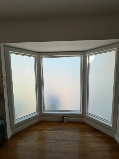 Three-panel bay window with switchable film — switched to frosted mode for instant privacy and UV protection
