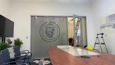 Properly installed switchable smart film on a conference room glass partition showing clean activation pattern