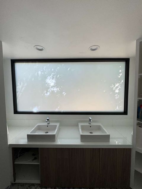 Frosted-mode switchable smart film bathroom window demonstrating morning-routine privacy as part of whole-home upgrade spec