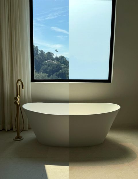 Before-and-after of a bathroom window and freestanding tub switching from clear to frosted with Smart View smart film