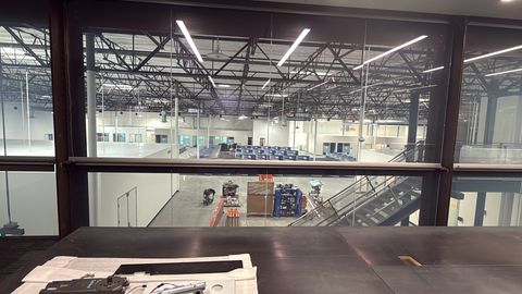 A Smart View installer fitting switchable smart film to a glass wall in Carlsbad
