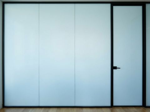 The same executive office glass wall switched to frosted privacy mode — flat, even, opaque smart glass