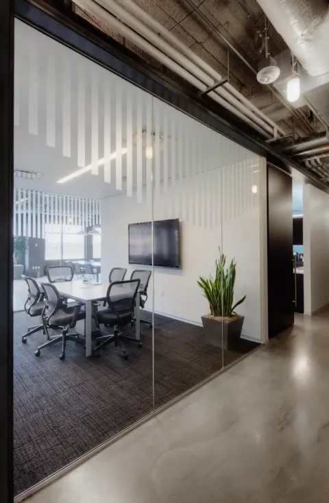 Switchable Smart Frosted Stripe film on floor-to-ceiling glass walls in a conference room install
