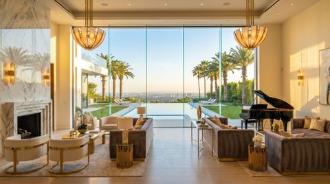 Beverly Hills estate with a floor-to-ceiling clear switchable smart glass wall overlooking palm-lined grounds and an infinity pool