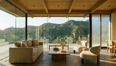 Glendale modern home with a floor-to-ceiling clear switchable smart glass wall overlooking the Verdugo foothills — several glass panels switched to frosted privacy mode