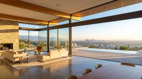 Los Angeles hillside home with a floor-to-ceiling clear switchable smart glass wall overlooking the LA basin