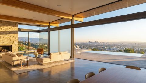 A Smart View installer fitting switchable smart glass on a Los Angeles project — several glass panels switched to frosted privacy mode