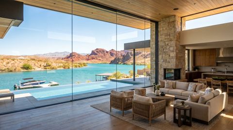 Lake Havasu City waterfront desert home with a floor-to-ceiling clear switchable smart glass wall overlooking the lake and red mountains