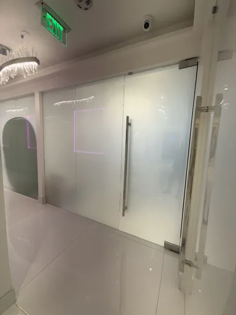 The same Beverly Hills surgery-clinic glass switched to frosted: a flat, even milky-white privacy wall on one switch