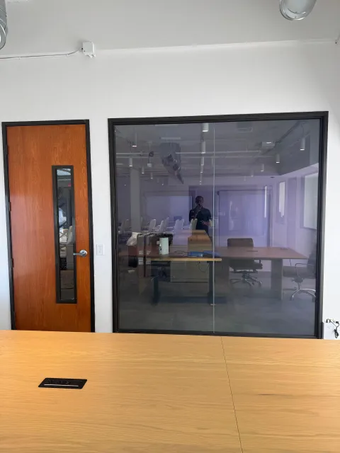 Real Smart View install: a switchable smart glass conference-room wall in a Newport Beach office in its clear, powered-on state