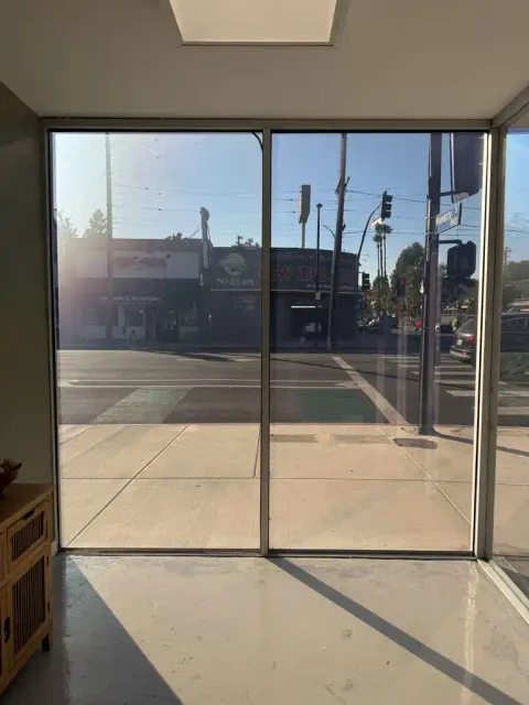 Smart glass storefront Reseda in clear mode — 60 sqft PDLC film on a retail shop's ground-floor windows