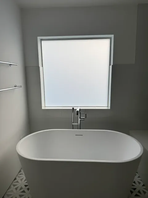 Smart glass bathroom window in Eagle Rock Los Angeles in privacy mode above freestanding bathtub