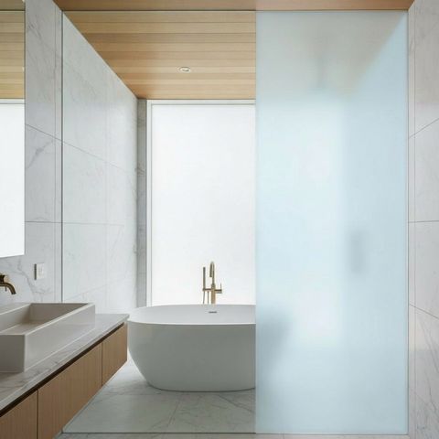 The same glass enclosure switched to frosted privacy in under a second