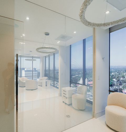 Beverly Hills suite glass wall in clear mode — see straight through to the downtown Los Angeles skyline