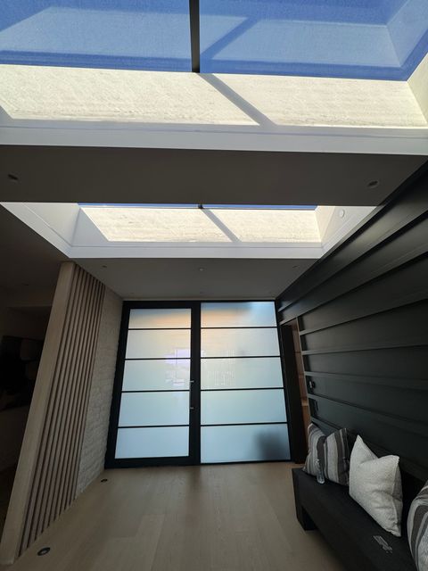 Same entry hall view with the door and full-height side panel frosted for privacy