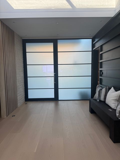 Smart film front door in Newport Beach frosted milky white, daylight still filling the hall