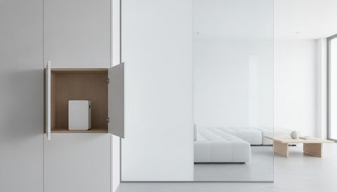 Illustration of a compact smart film transformer power supply concealed inside a cabinet compartment beside an interior switchable smart film partition, one pane frosted an even milky white and one clear