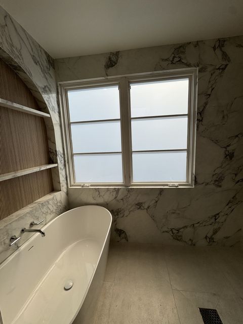 Smart glass bathroom in Hermosa Beach with the casement window frosted to an even milky white for full privacy