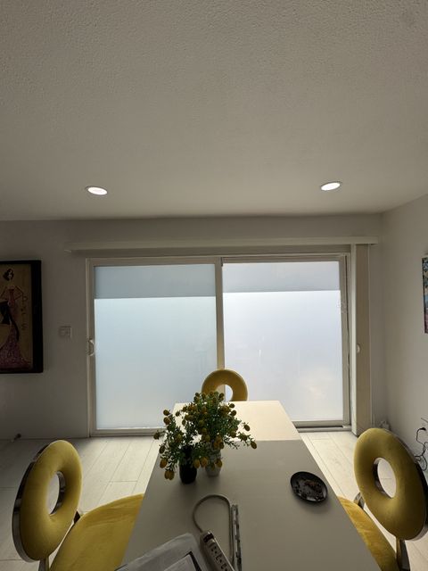 Camarillo sliding door with the smart glass frosted to an even milky white for privacy, still carrying daylight into the room