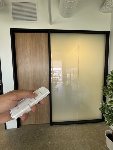 Smart glass office partition in El Segundo switched to flat milky-white frost for privacy
