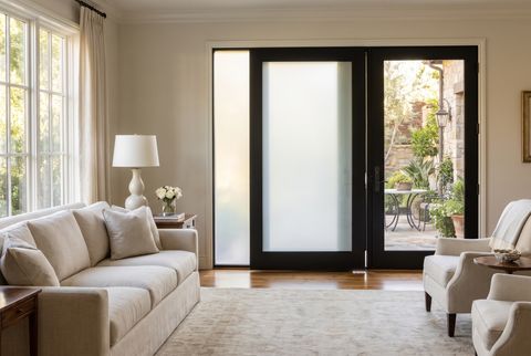 Illustration: a pair of French doors viewed from inside a room — the left door's panes clear onto a green garden, the right door's panes switched to an even milky frost