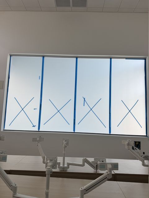 The same Los Angeles classroom window with the smart glass in frosted privacy mode, still carrying daylight into the room