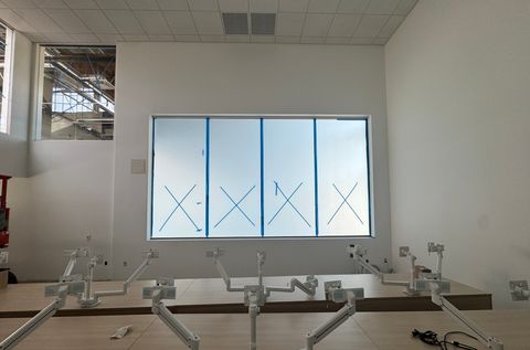 Los Angeles school classroom with the smart glass window band frosted to an even milky white above the workstation benches