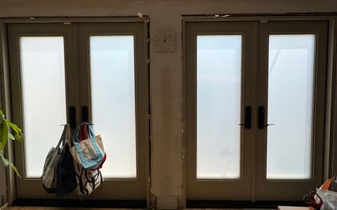 Switchable french doors in frosted privacy mode in a Los Angeles residence