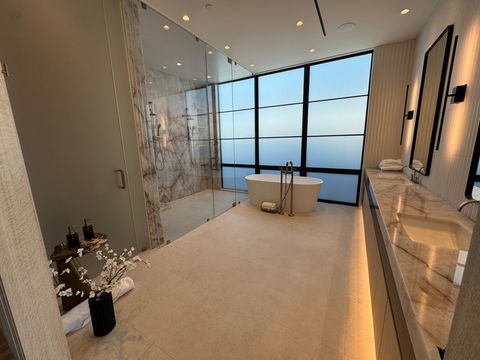 Same Newport Beach master bath with the tub window frosted, daylight still filling the room