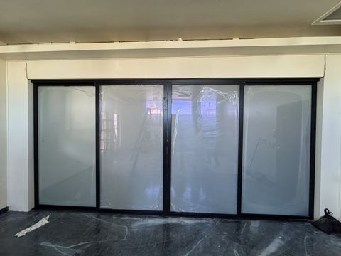Real Smart View install: four-panel sliding glass doors at a Gardena office switched to an even white frost for meeting privacy
