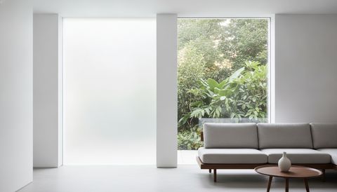 Illustration of two matching home windows side by side, one pane frosted an even milky white and the other clear with a garden view