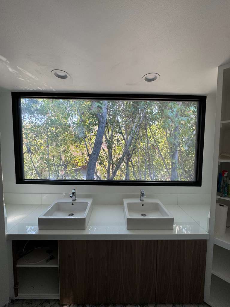 Smart film for big windows — large clear-mode glass window in an LA residential install showing daylight transmission and architectural-scale spec quality
