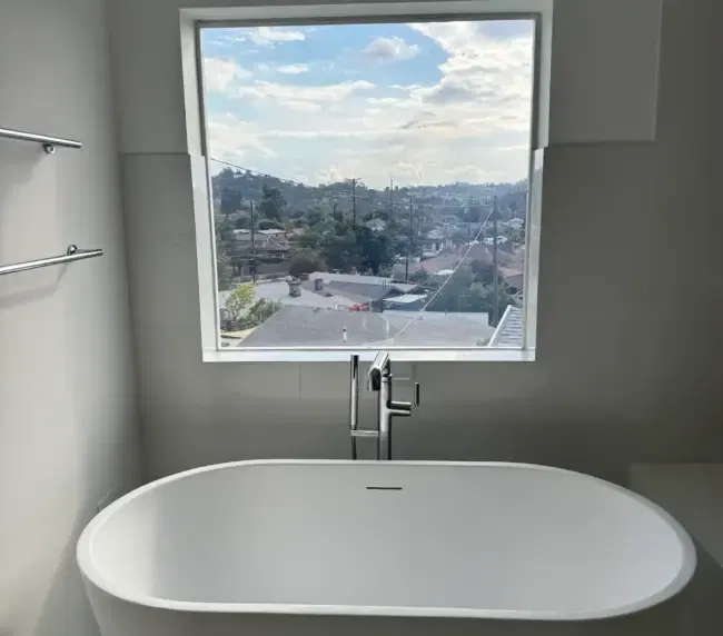Smart glass bathroom design ideas in practice — modern bathroom with privacy-on-demand switchable film on a Los Angeles residential window